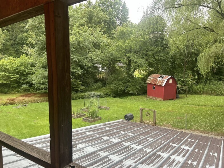 Backyard view from back porch. 1 acre property with creek - 3393 Mobile Rd