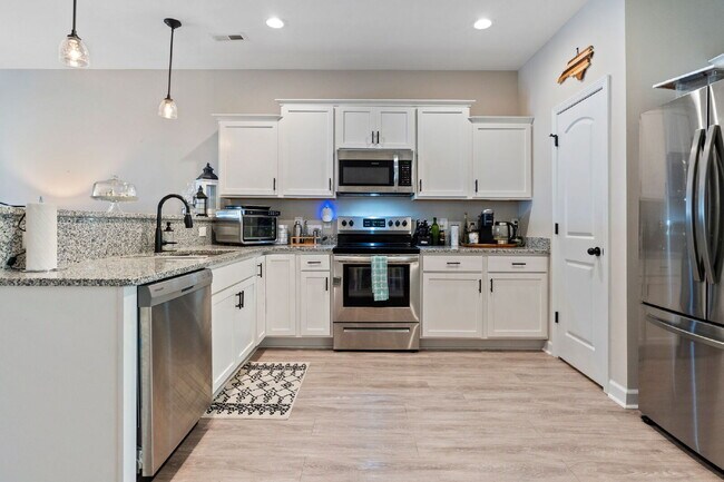 Building Photo - Available Now! Enjoy low-maintenance coastal living in this beautiful 2-bedroom, 2.5-bath townhom...
