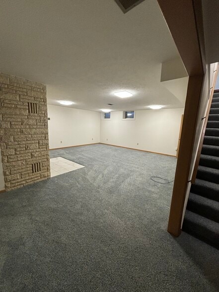 Carpeted basement living space - 815 E 6th St