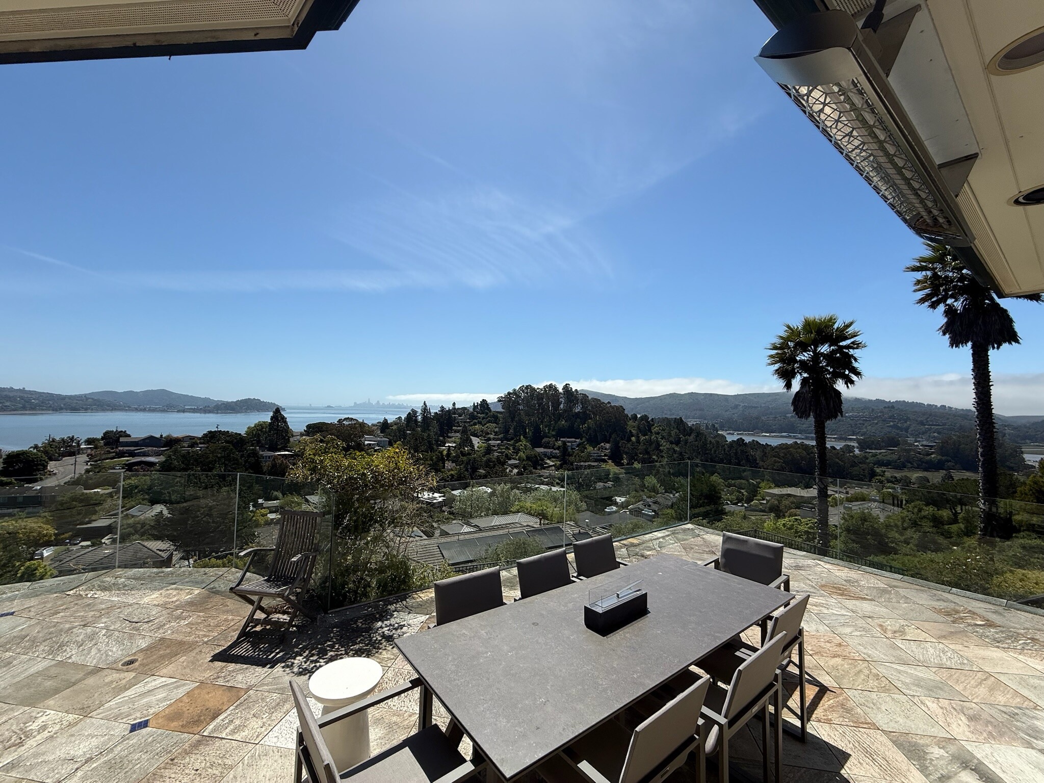 Upper deck with glass railings for unobstructed views and powerful built-in heat lamps. - 115 Inez Pl