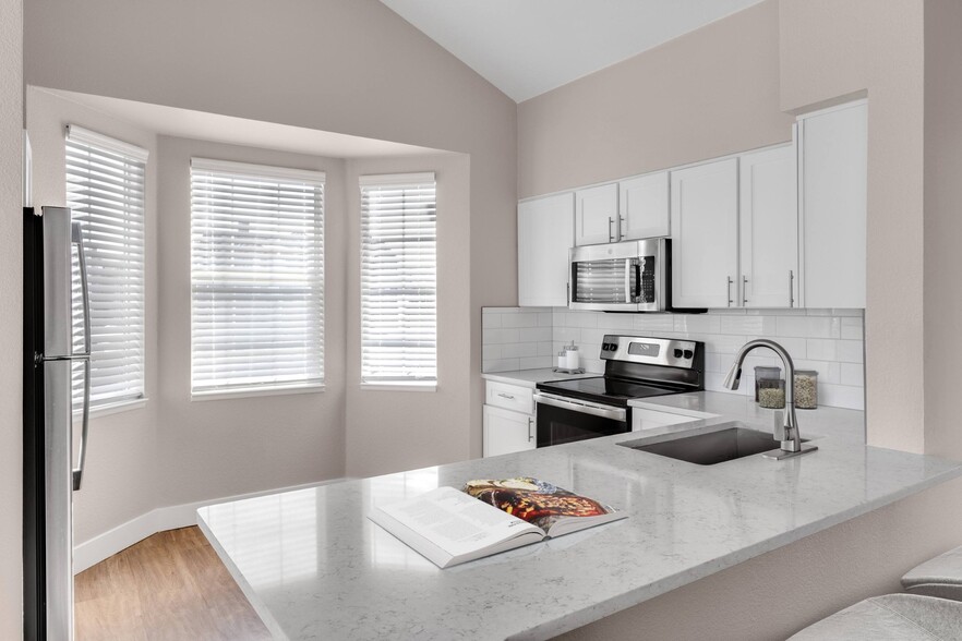 Kitchen with breakfast bar at The Links at Plum Creek in Castle Rock, CO - The Links at Plum Creek