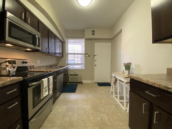 Kitchen with rich wood cabinetry - 2 Bedroom A - 2849 N Orchard