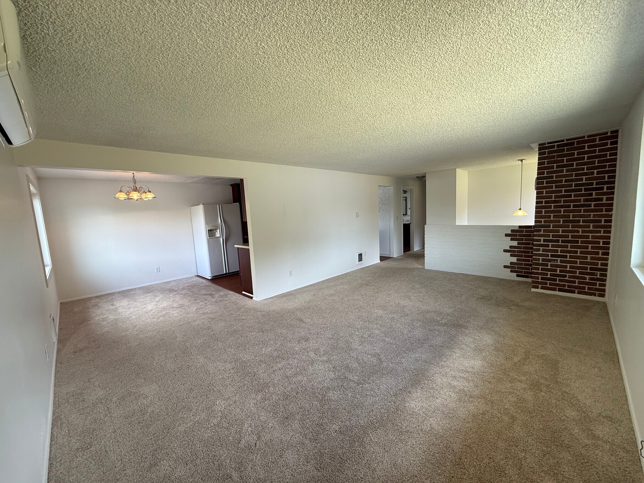 Living room and dining room facing hallway and stairs to front door - 13016 16th St NE