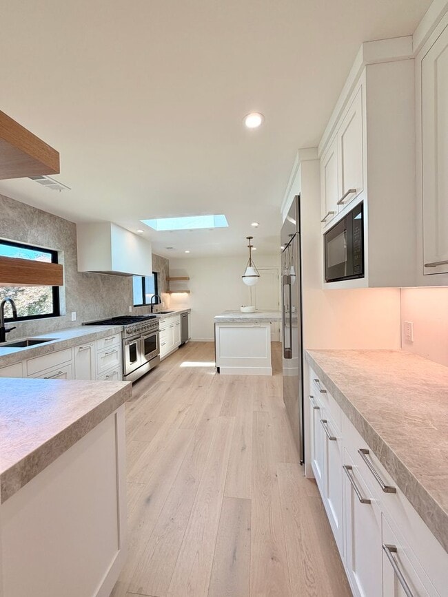 Building Photo - This premier 4-bed, 3-bath estate spans 2,565 sq. ft. on a 10,253 sq. ft. lot in North Los Altos.