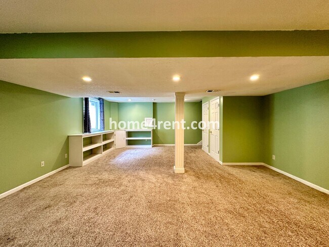 Building Photo - Beautiful Four-Bedroom Home with Three Car Garage, Wood Floors, Finished Basement and a Fenced Ya...