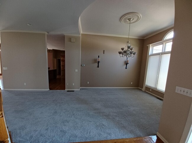 Lighting option that casts a warm, inviting glow over formal dining area. - 6003 N Norton Ave