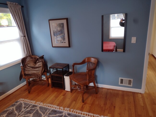 Primary bedroom with thermal blackout curtains. Reading corner. - 4157 SE Brooklyn St