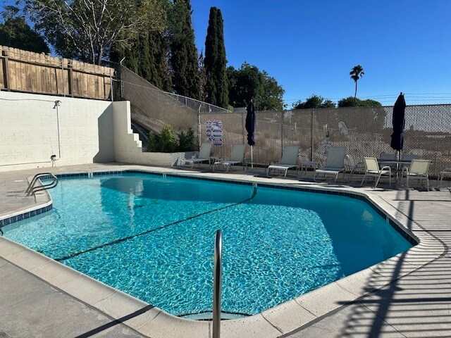 Sunny pool area with plenty of space to unwind. - 5510 Adelaide Ave