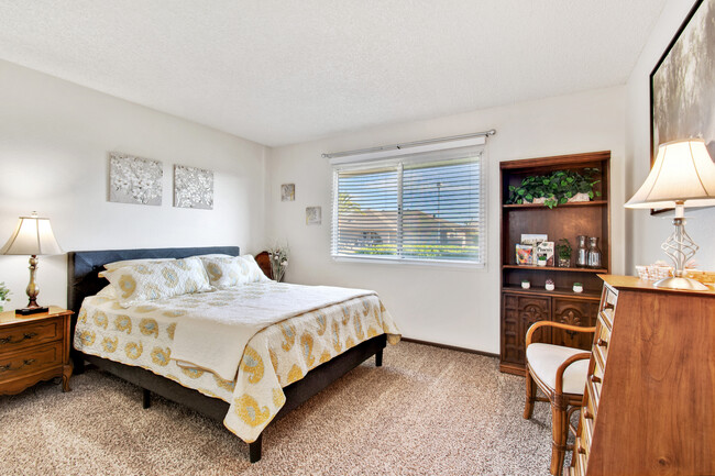 Guest bedroom has a queen-size bed and plenty of storage, including a walk-in closet. - 12414 W Nugget Ct