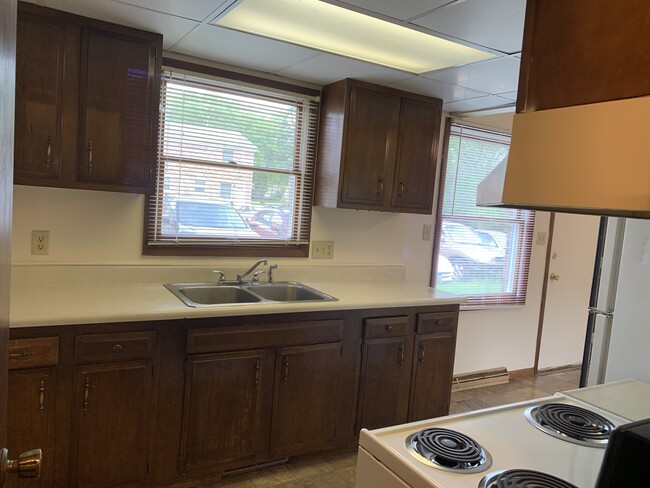 Galley kitchen, disposal in sink, east facing windows for lots of morning light. - 1320 5th St W