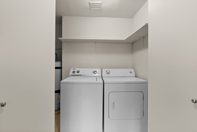 Convenient in-unit laundry with modern washer and dryer in a bright, organized space. - Windemere Apartments
