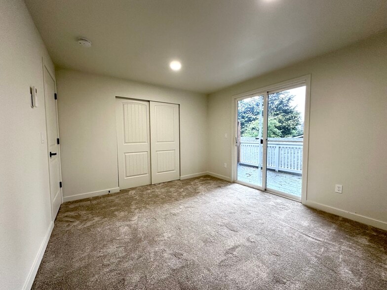 Bedroom 1 with a balcony, new carpet, paint, split - 1014 W 23rd St