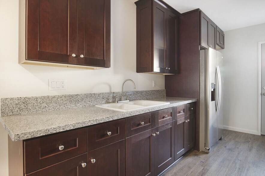 remodeled kitchen with stainless steel stove, washer/dryer and refrigerator - 4091 Rosecrans Ave