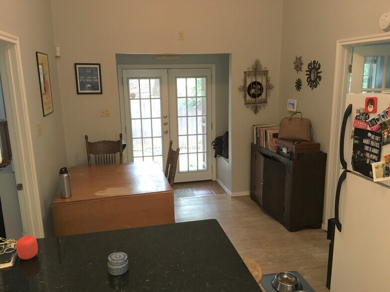 Entryway and kitchen eating area, storage benches on either side of front entry. - 4302 Duval Street