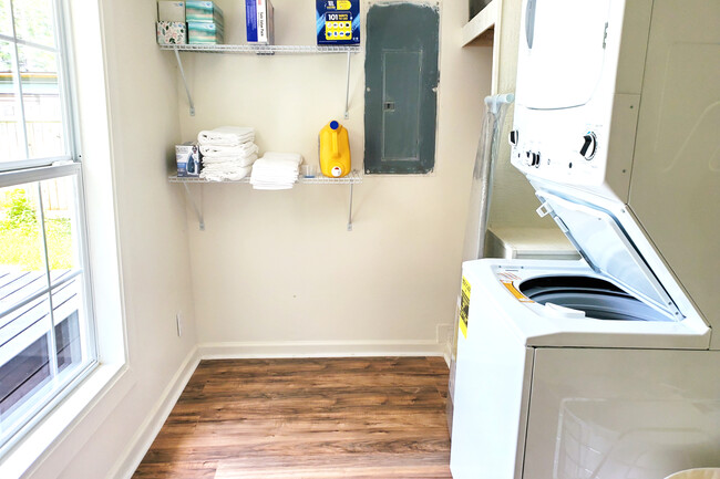 Laundry area with stackable washer and dryer. Plenty of storage for cleaning supplies. - 1010 W Chestnut St