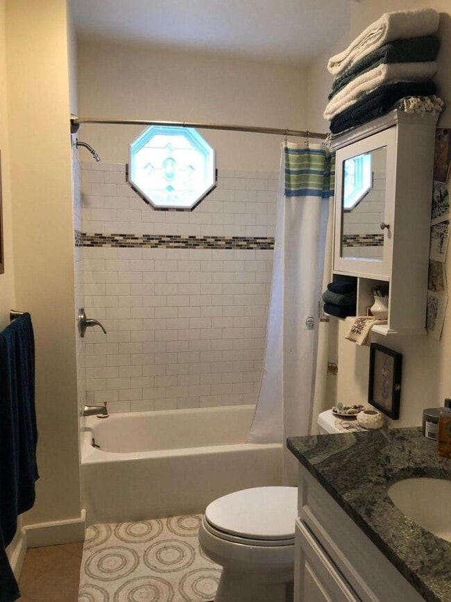 White subway tiled shower and tube with granite vanity - 23 Savoy St