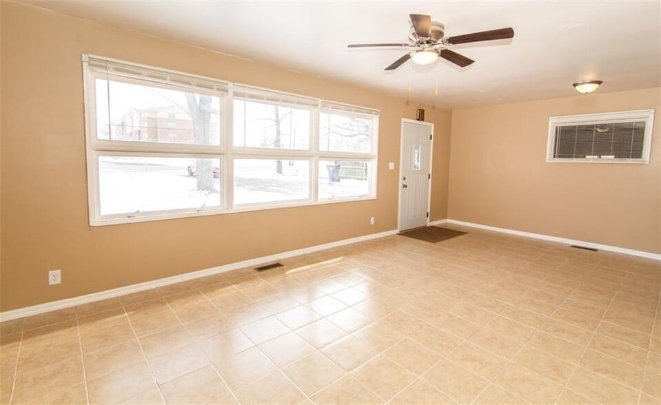 Living room boasts lots of natural light, an updated ceiling fan and easy maintenance tile flooring. - 2950 N Ritter Ave