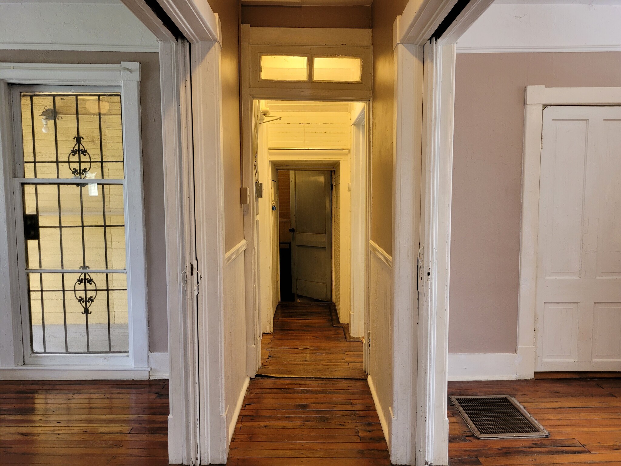 View down the main hall from between parlor pocket doors to laundry room (before exterior repainted) - 1215 Java Pl