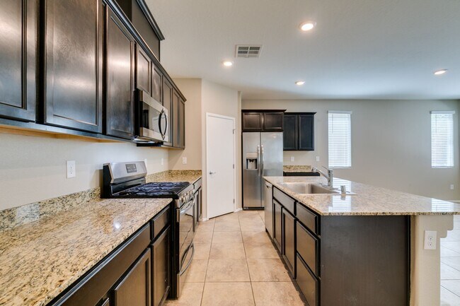 Building Photo - Spacious Townhouse with Loft & Rare 3-Car Garage!