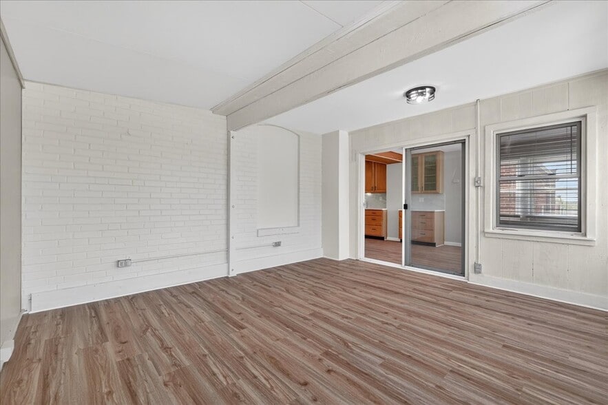 Sunroom-style bedroom surrounded by windows—bright, airy, and perfect as a primary or creative space - 5185 Goethe Ave