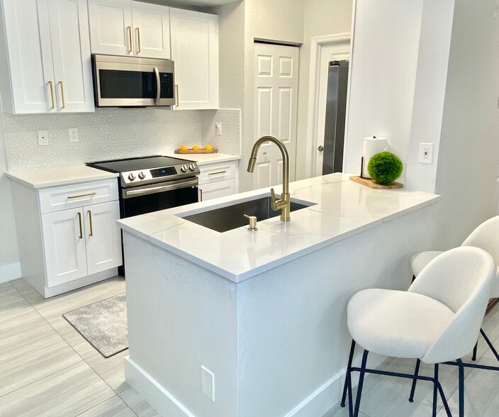 Modern kitchen with solid wood cabinets and new appliances. - 4645 Saint Croix Ln