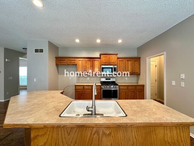 Building Photo - Beautiful Four-Bedroom Home with Three Car Garage, Wood Floors, Finished Basement and a Fenced Ya...