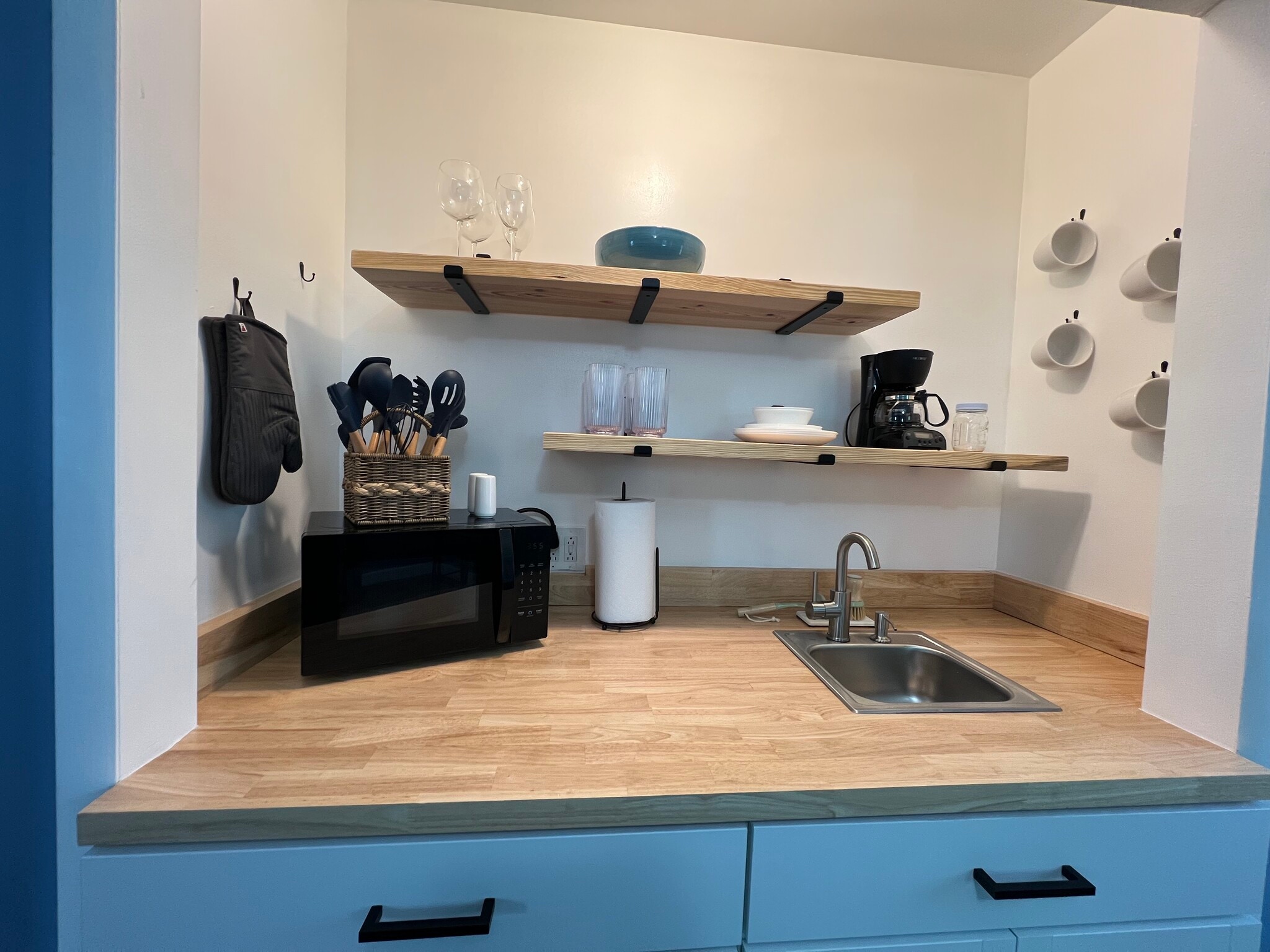 Plates, cups, dishes, microwave, cooking utensils, coffee maker, and mugs. A sink to clean dishes.. - 908 Lake Rd