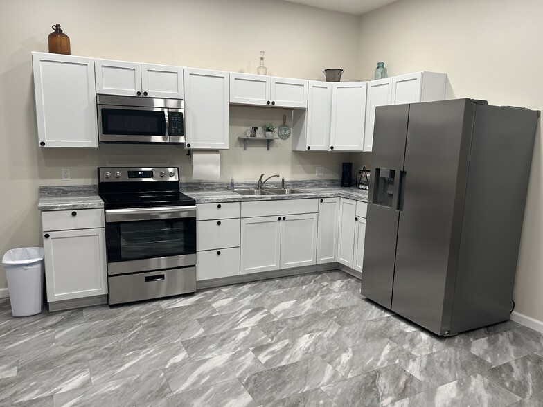 Fully furnished kitchen with microwave, stove, fridge - 812 Commercial St