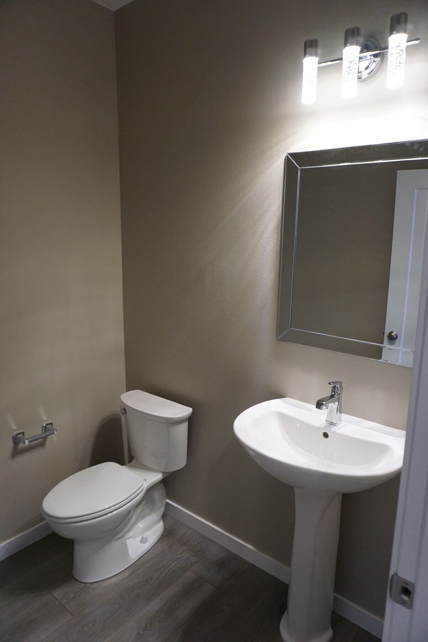 Half bath off of entry hallway (Photos are of similar unit with similar finishes.) - 3811 Stacy Drive