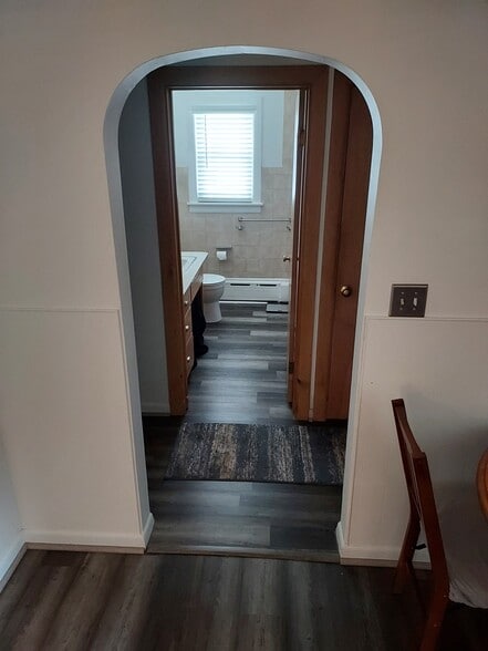 New flooring in the living room, hallway, and bathroom. - 1145 Cleveland Dr