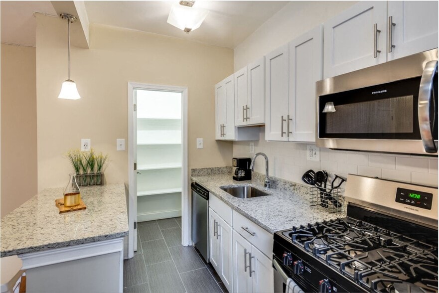 Renovated kitchen with stainless steel appliances and granite countertops - Kew Gardens