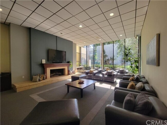 Community media room with fireplace - 436 N Bellflower Blvd