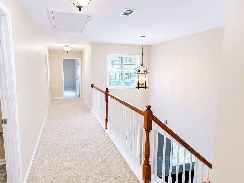 Open, airy foyer with overlook to entrance area below, adding architectural elegance and a sp - 2143 Somerset Pl SE