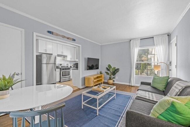 Living room with kitchen view - 881 North Highland Apartments