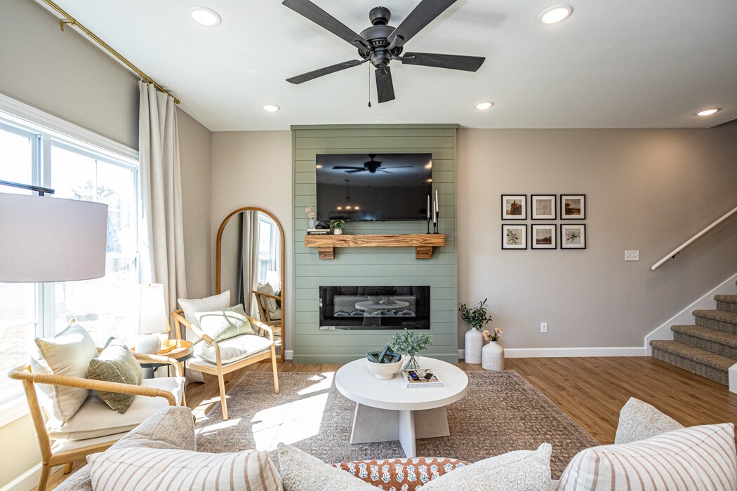 living room featuring open concept layout, decorative mantle and electric fireplace - 110 Sierra Cir