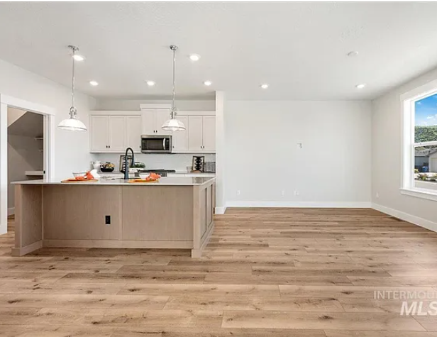 Open concept kitchen living room - 5556 W Elk Trail St