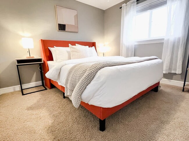 Bedroom 1 - Queen-sized mattress with two nightstands and bedside lamps with USB charging hubs. - 1237 Giesse Dr