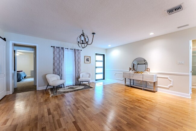 Building Photo - Lake Jessamine Luxury: Solar-Powered Waterfront Retreat on 1.14 Acres with Dock & Boathouse