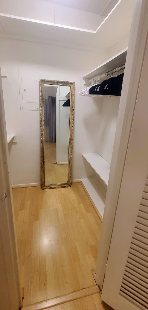 Walk-in closet with lots of shelves and hanging rods. - 3 Island Ave