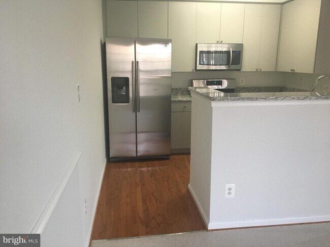 Building Photo - Welcome to this beautifully appointed two level upper condominium that combines modern style with...
