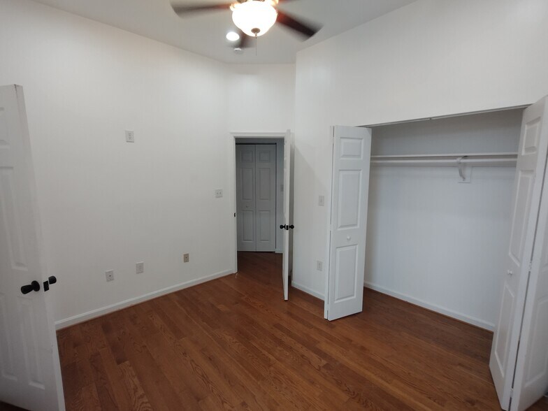 Second Bedroom Comfortable second bedroom featuring a large window for natural light, wood floors, r - 1933 4th St NW