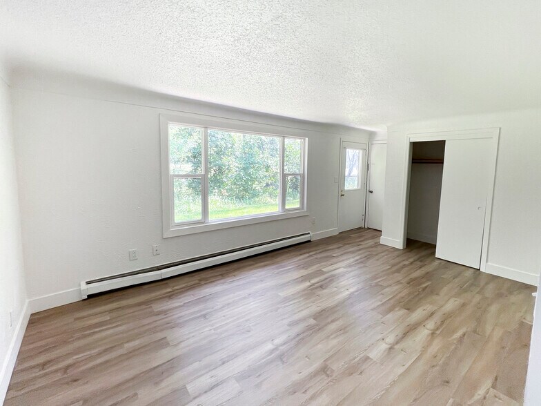 Large entry closet in bright living room with new floors thoughout. - 1651 10th Ave