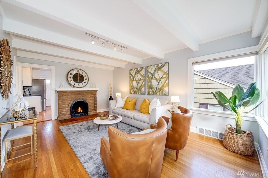 Formal Living room with fireplace and box beam ceiling. - 4749 37th Ave SW