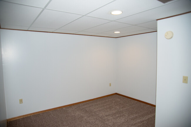 Basement bedroom with new carpeting. - 1911 Talmage Ave SE