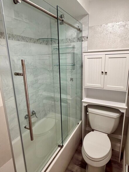 Renovated full bath with glass enclosure - 105 4th Ave NE