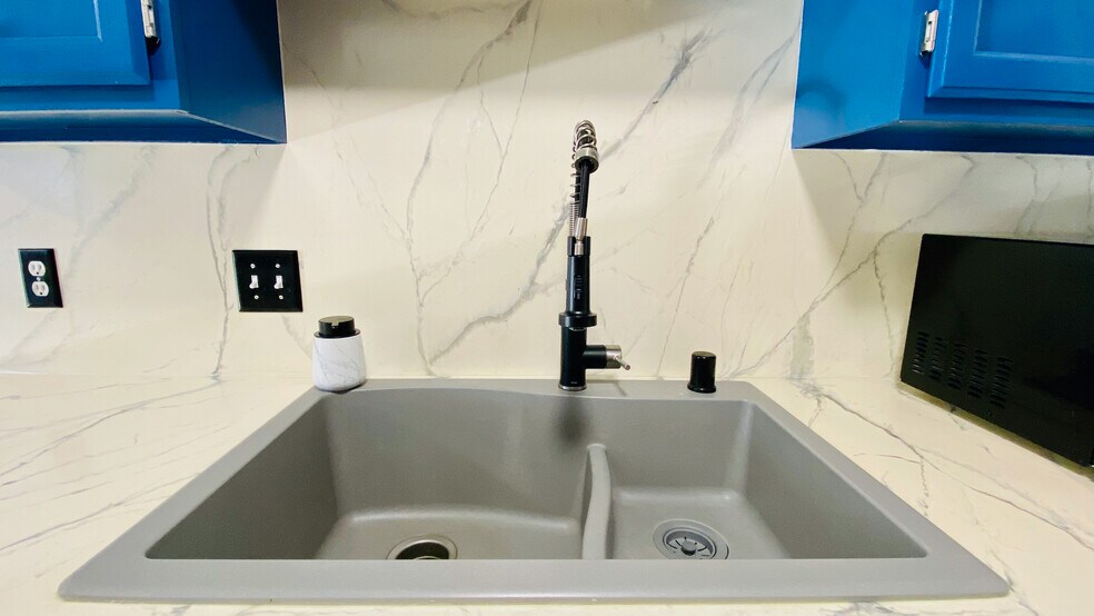 Epoxy/marble backsplash with modern sink and workhorse facuet. - 384 Minz Park Cir