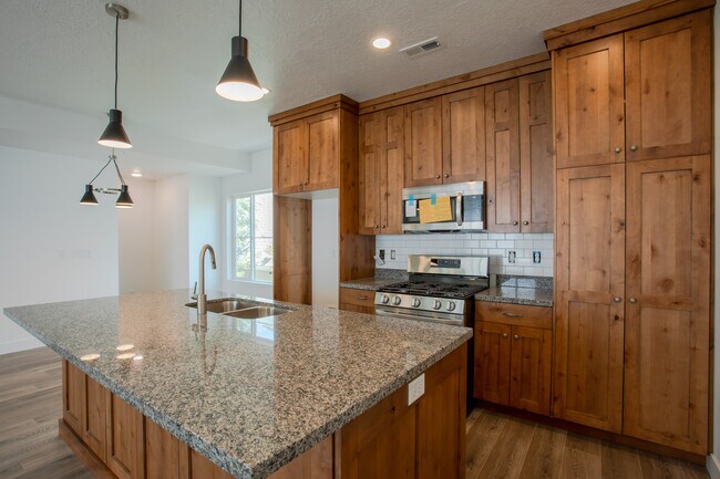 Kitchen with stainless fridge, dishwasher, gas range, microwave and subway tile backsplash. - 361 W Reed Ave