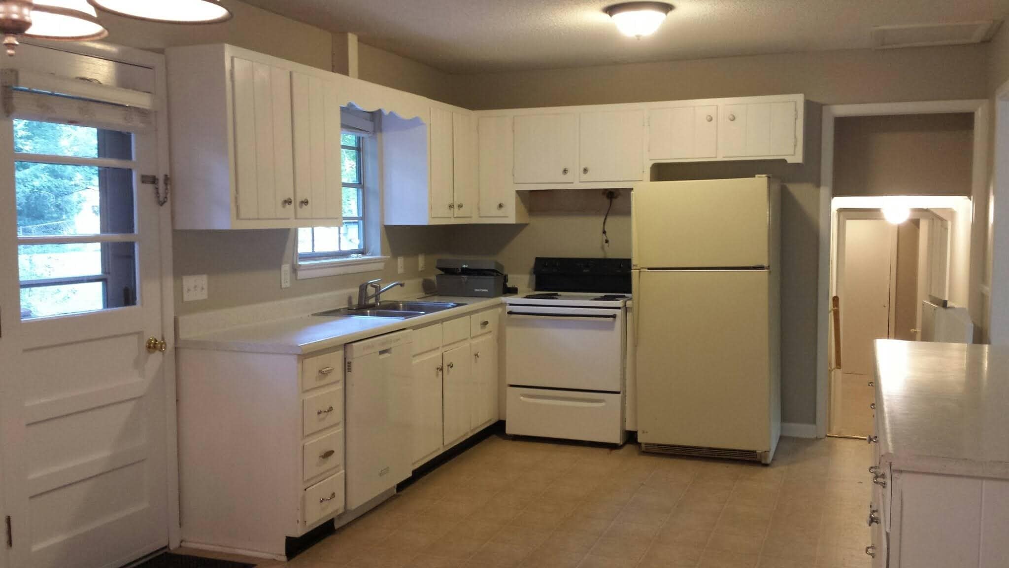 OLD PHOTO before cabinets and range were replaced last year but shows full layout with fridge. - 826 Murrell Rd