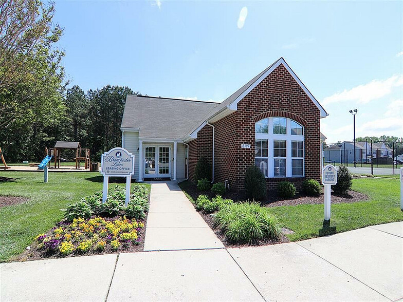 Welcome to our charming leasing office, surrounded by lush greenery and bright blooms. - Branchester Lakes