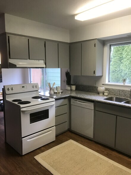 Kitchen with dish washer, oven, and refrigerator. - 8038 N Wayland Ave